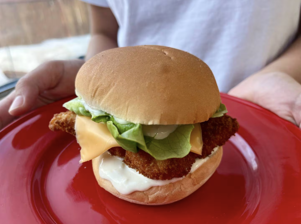 Fried fish pattie on a bun with lettuce and cheese